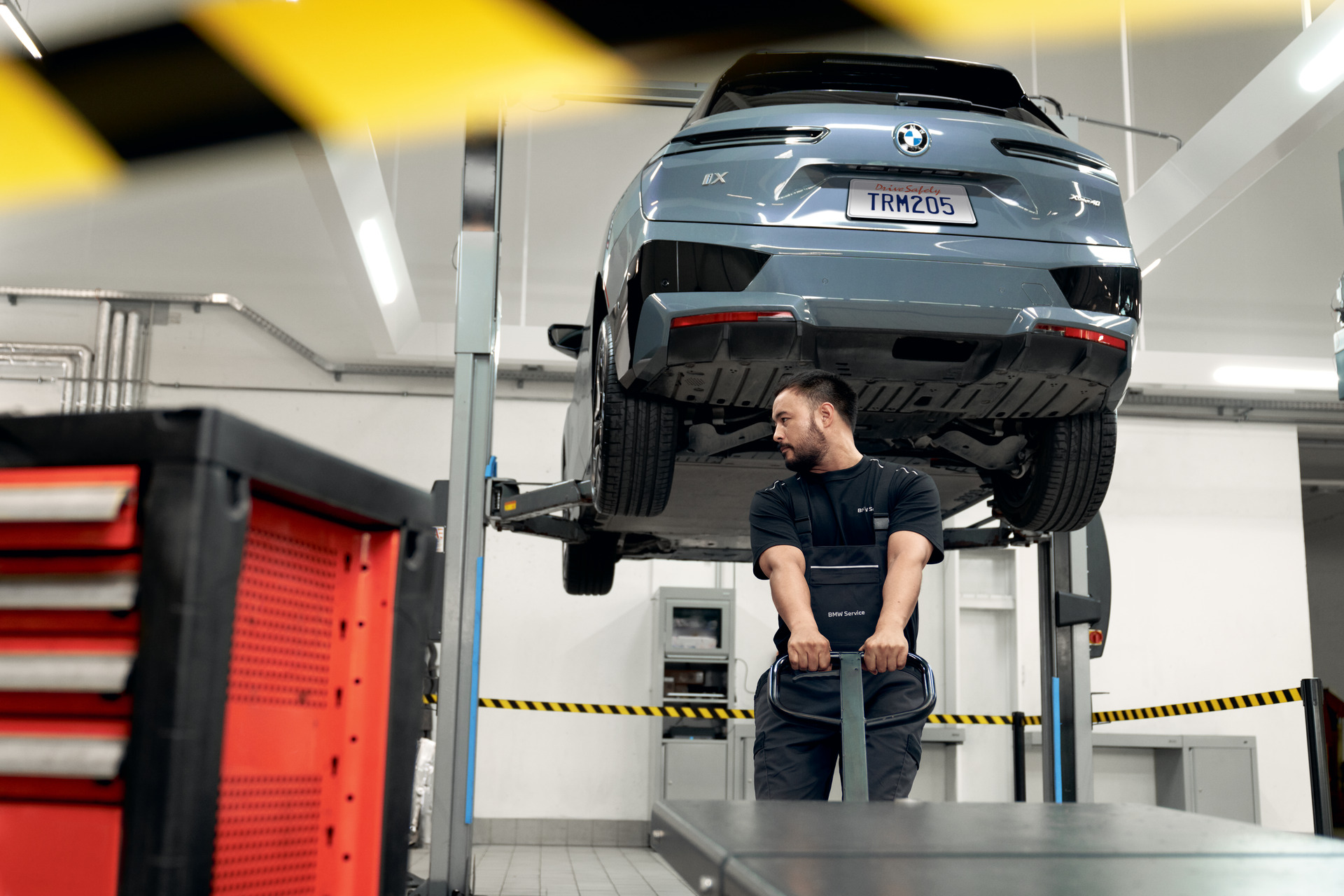 BMW raised on a lift for structural inspection inside the BMW of Jackson Certified Collision Repair Center