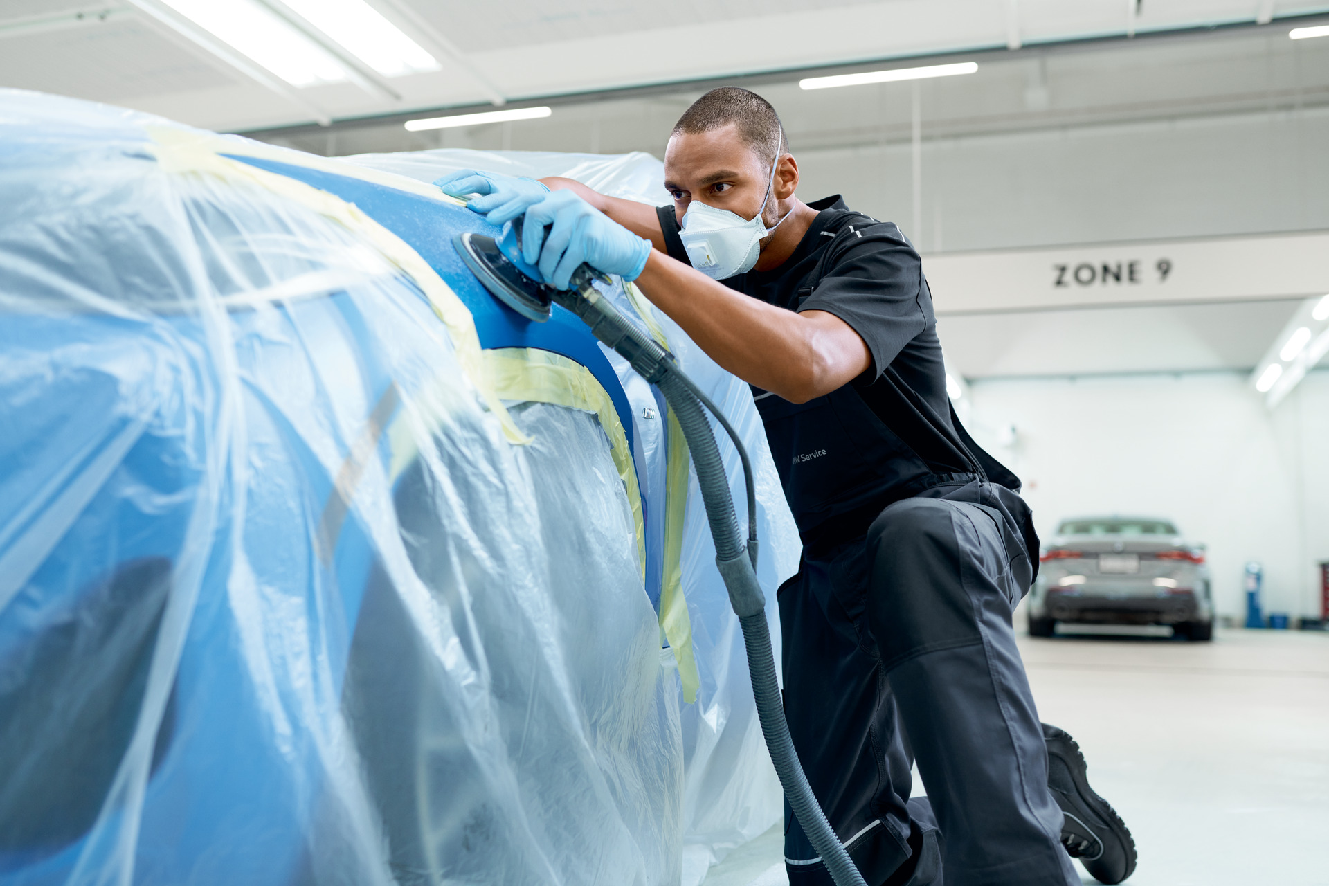 Paint refinishing preparation inside the BMW of Jackson Certified Collision Repair Center